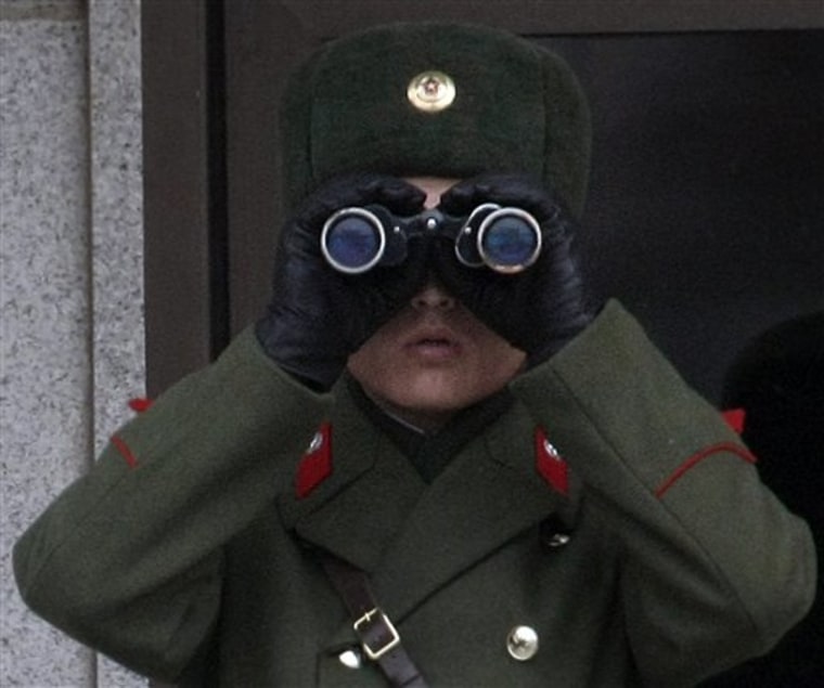 A North Korean soldier surveys the southern side at the border village of the Panmunjom, South Korea.